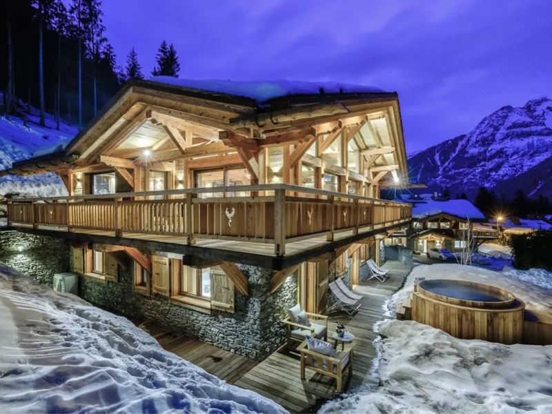 Chalet Saphir at nightfall, its hot tub steaming on a snow-lined terrace at Les Nants