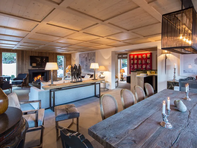 The dining room at Chalet Taupinière, candlelight on a long antique table, Courchevel