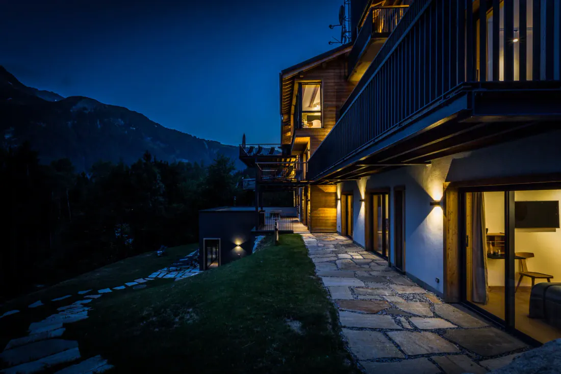 The living room in full daylight, windows to the peaks